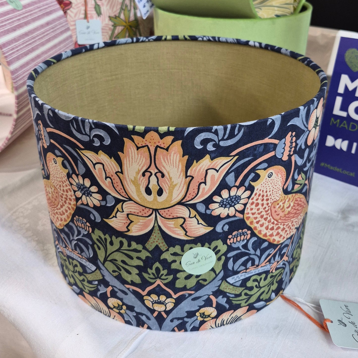 A 30 cm's drum shade covered in William Morris Strawberry Thief, in Indigo. Lined with a green linen.