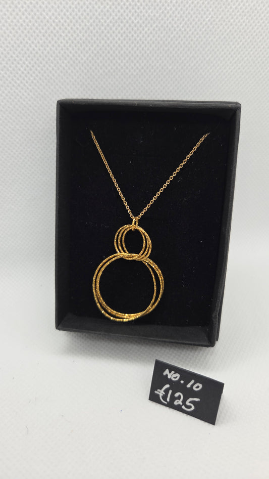 Gold chain with interlocking gold circle pendant