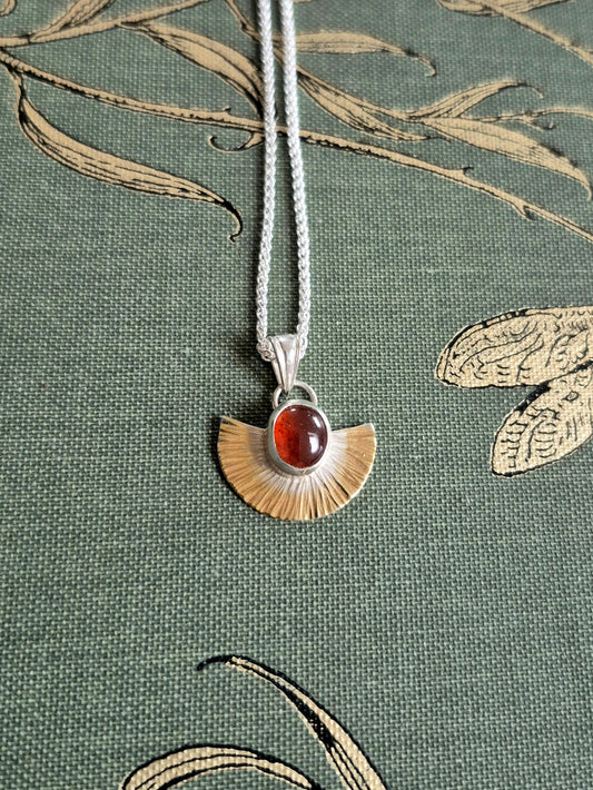 Isis pendant with orange garnet