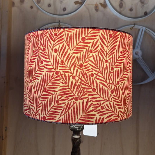 A handmade cotton and linen drum lampshade covered in William Morris Yew & Aril lined with an Irish Linen.