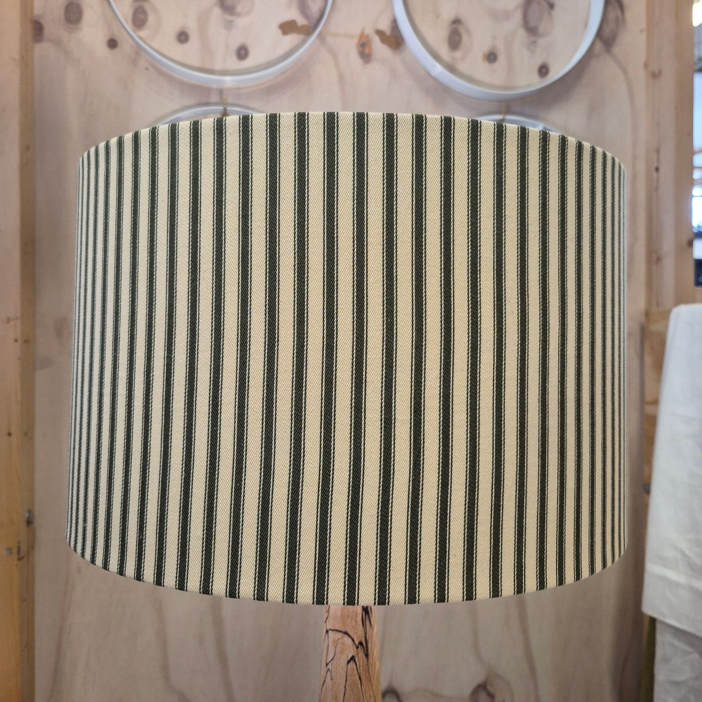 A classic vertical striped green and cream drum shade inspired by Howard & Sons ticking fabric.