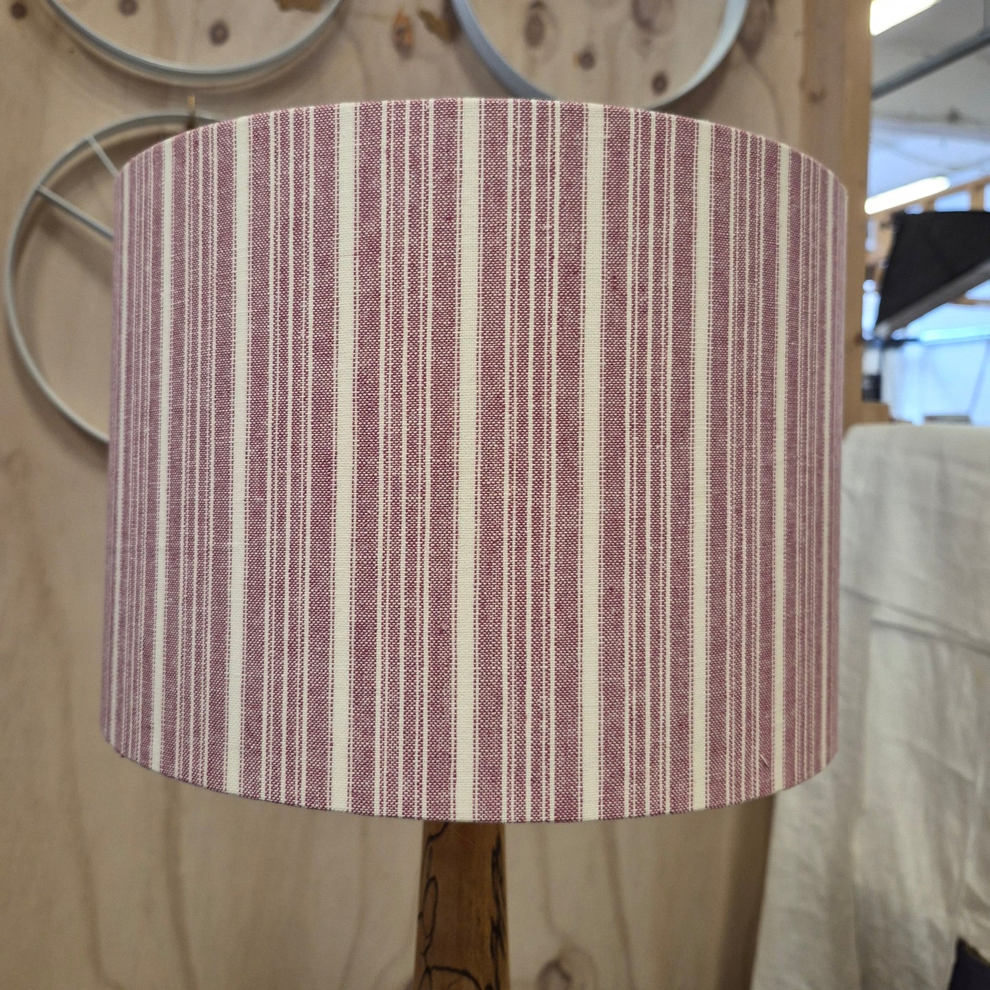 A 30cm drum shade covered in a cotton striped fabric, lined with a linen lining.