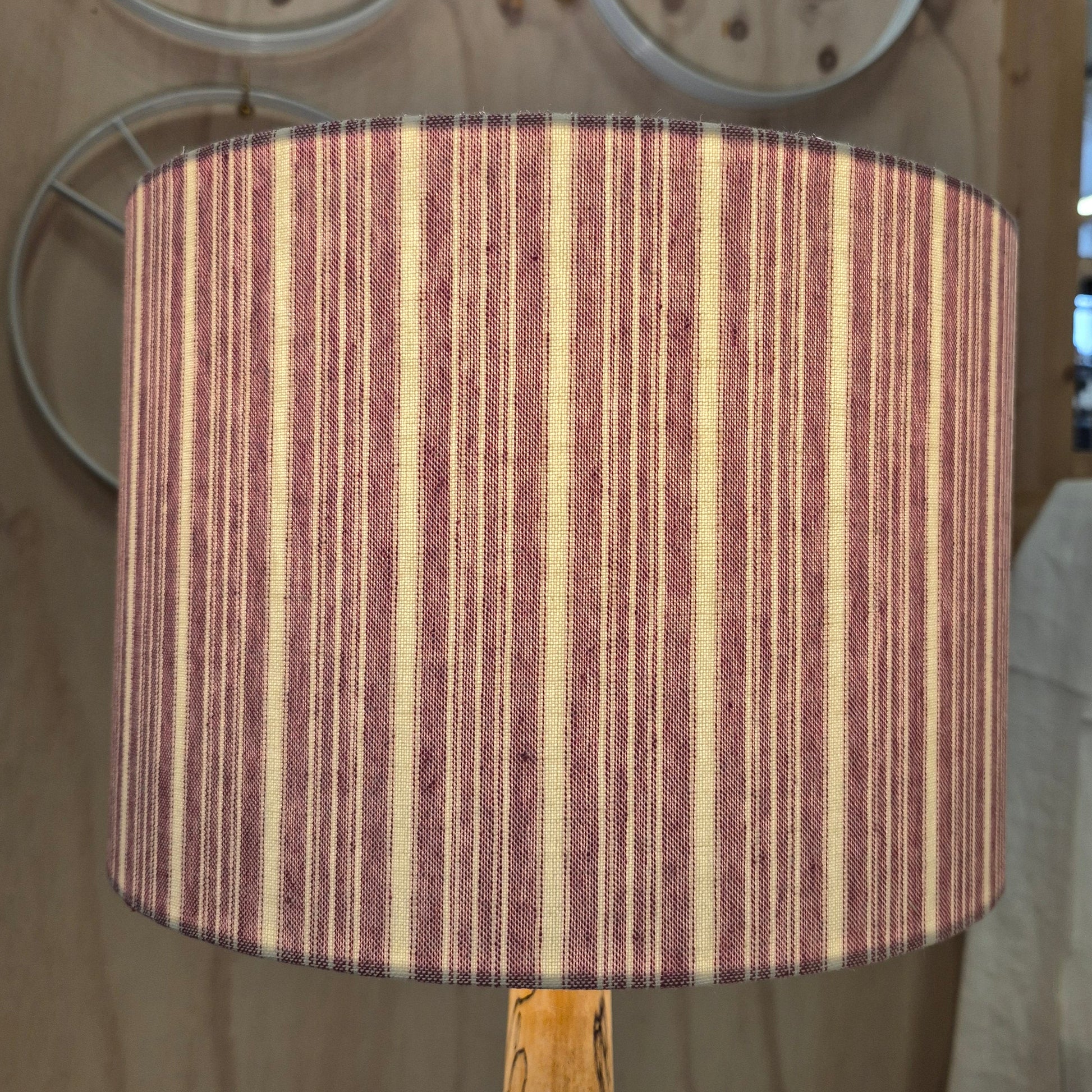 A 30cm drum shade covered in a cotton striped fabric, lined with a linen lining.