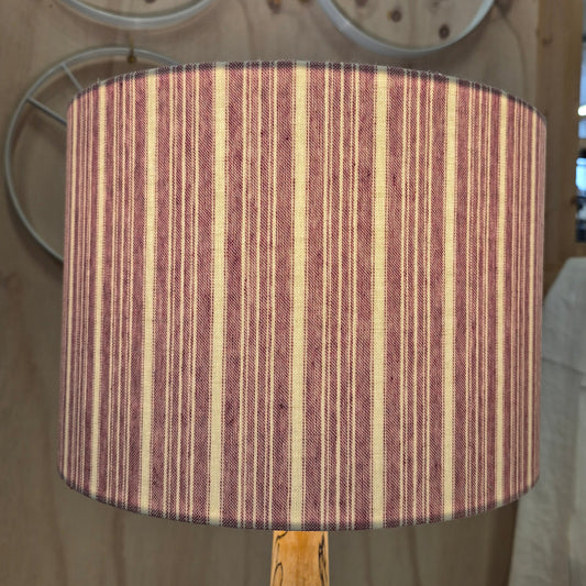 A 30cm drum shade covered in a cotton striped fabric, lined with a linen lining.