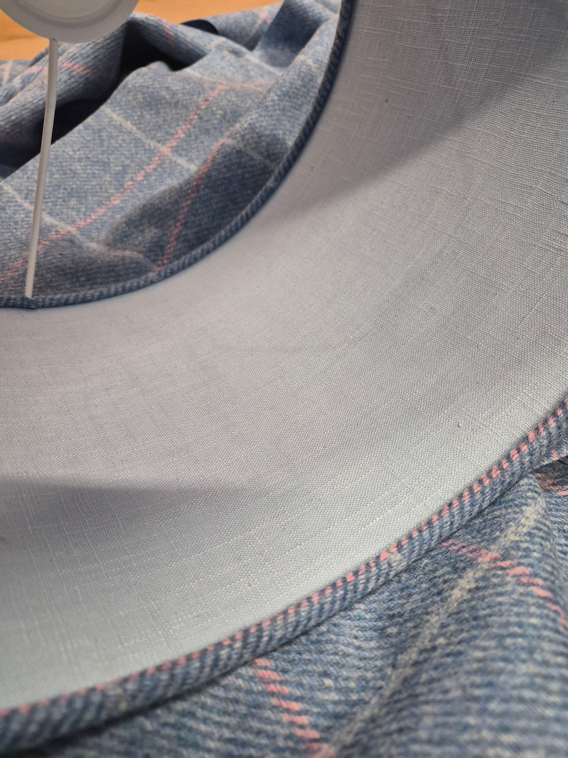 Close up image of the Yorkshire tweed drum shade showing detailed powder blue lining and edge detailing.